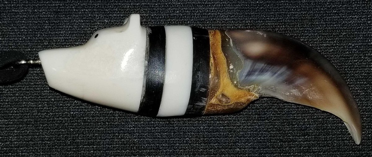 Carved and polished ivory and baleen bear claw pendant 