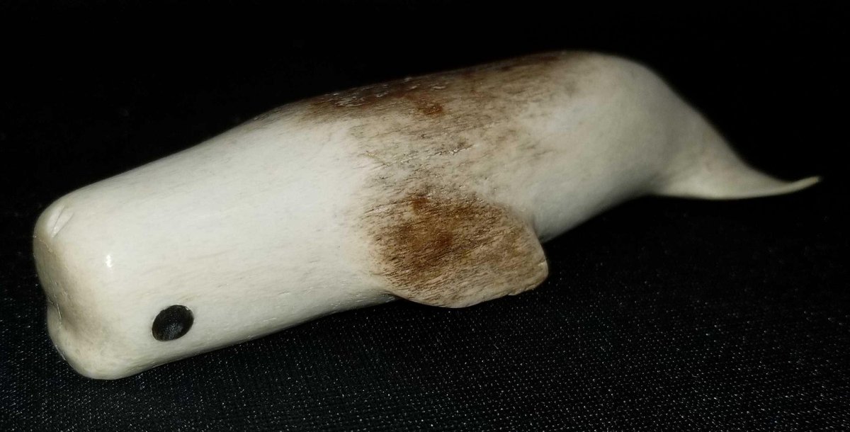 Carved fossilized whale bone whale 