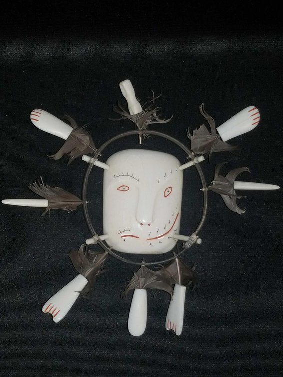 Scrimshaw ivory, baleen, and feather spirit mask 