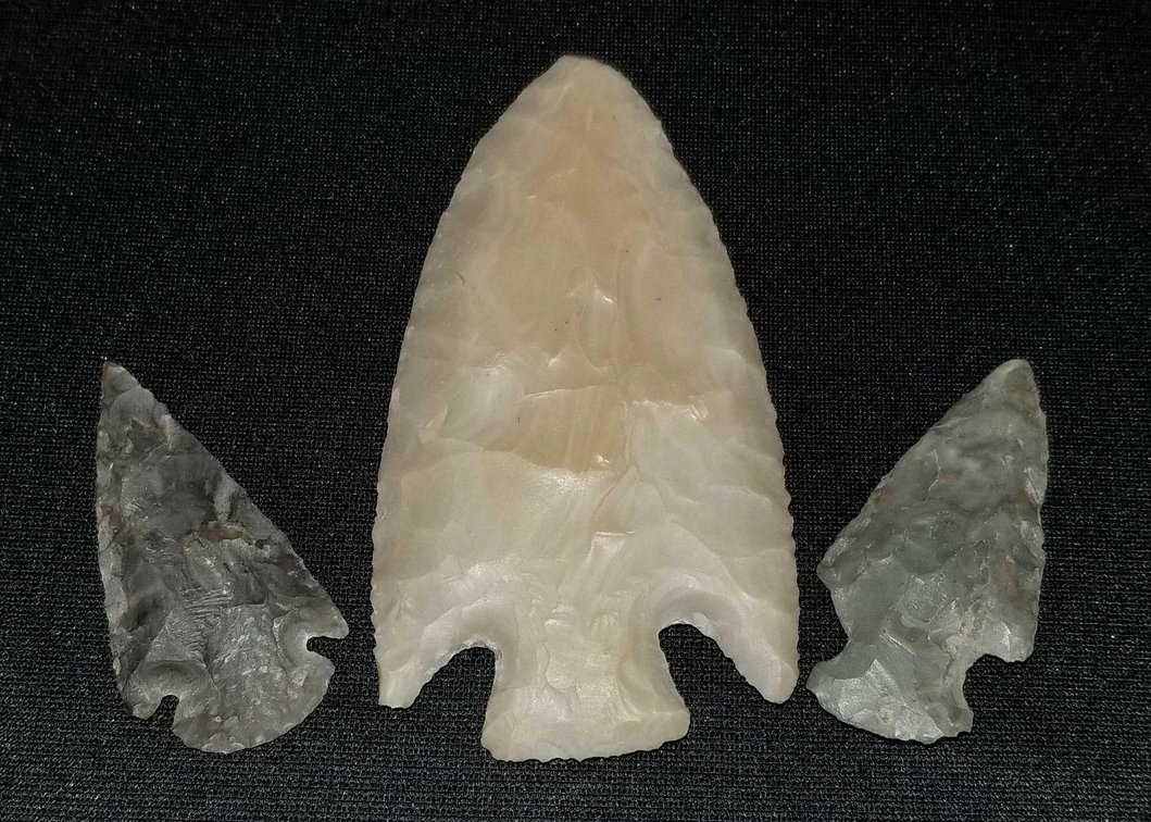 Collection of Native American arrowheads and a large spear tip