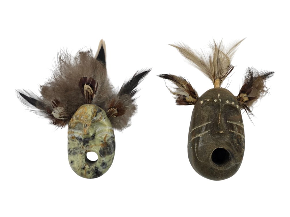 Two Miniature Stone & Feather Masks, One Signed ‘Tim’ and Attributed to Tim Henry