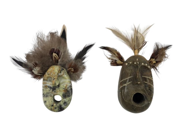 Two Miniature Stone & Feather Masks, One Signed ‘Tim’ and Attributed to Tim Henry
