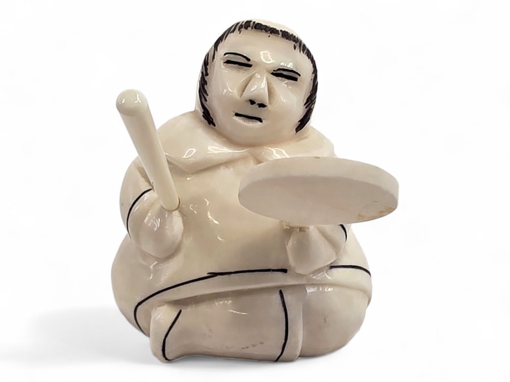 Whale-Tooth Carving of a Seated Drummer with Scrimshaw Details