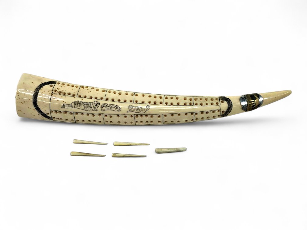 Gilbert Taxac Scrimshaw Walrus Ivory Cribbage Board, Inscribed Age 14, with Pegs