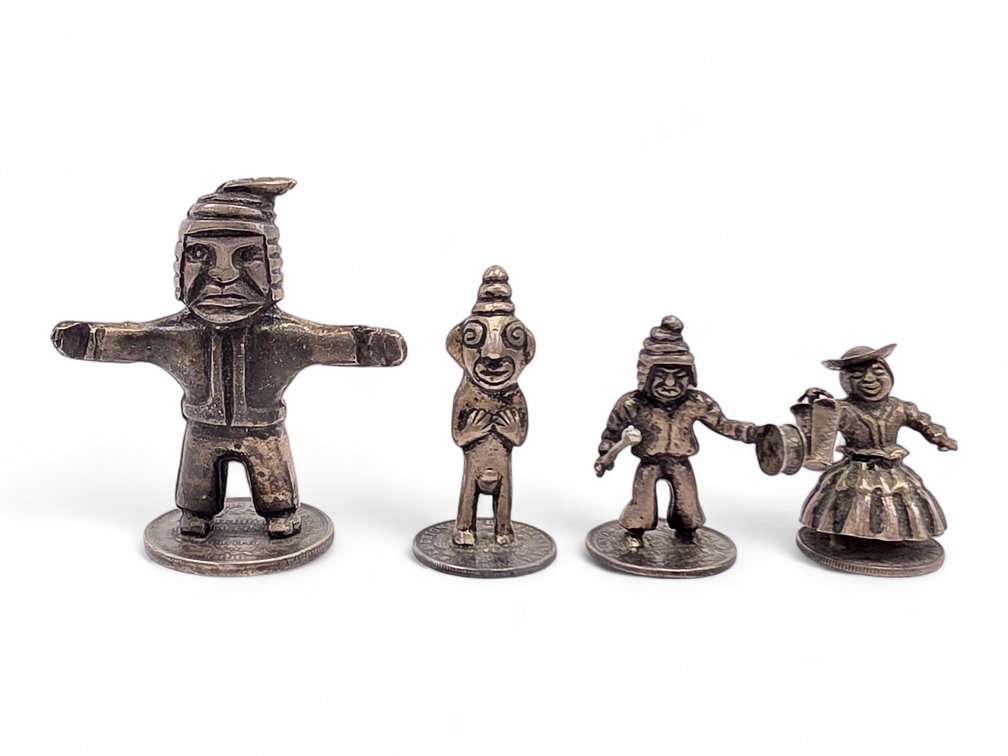 Four Silver Figures Mounted on Bolivian Coins, 141.06 Grams Gross
