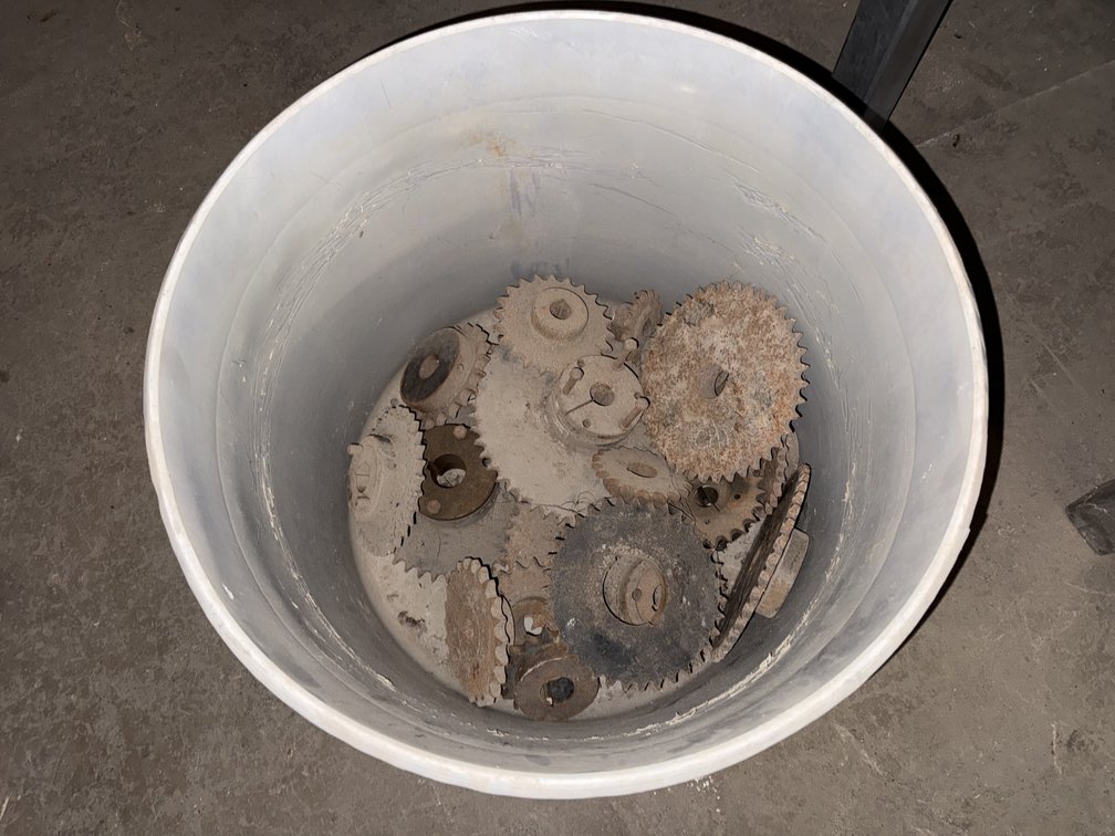 Assorted Industrial Metal Sprockets and Gears in Plastic Drum