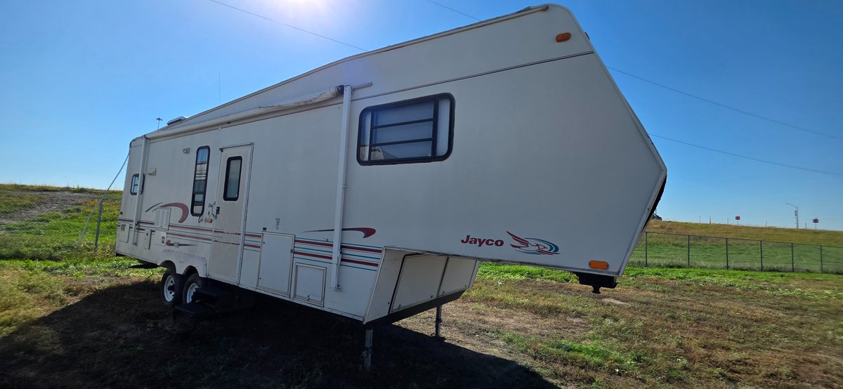 1998 Jayco 293, 12 ft slide, awning needs work, front end and rear end water damage, no LP tanks, interior needs a lot of work, does have a fridge & stove, but trailer overall needs a lot of work