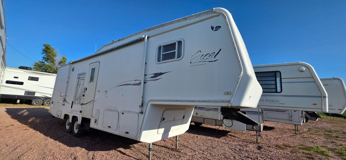 2000 Excel 30 rgw fifth wheel camper, 18' awning, 13' slide, 6' bedroom slide, tires good, hard shell, overall appearance ain't too bad, interior looks pretty good, little TLC would be a great fixer up camper, no LP tanks