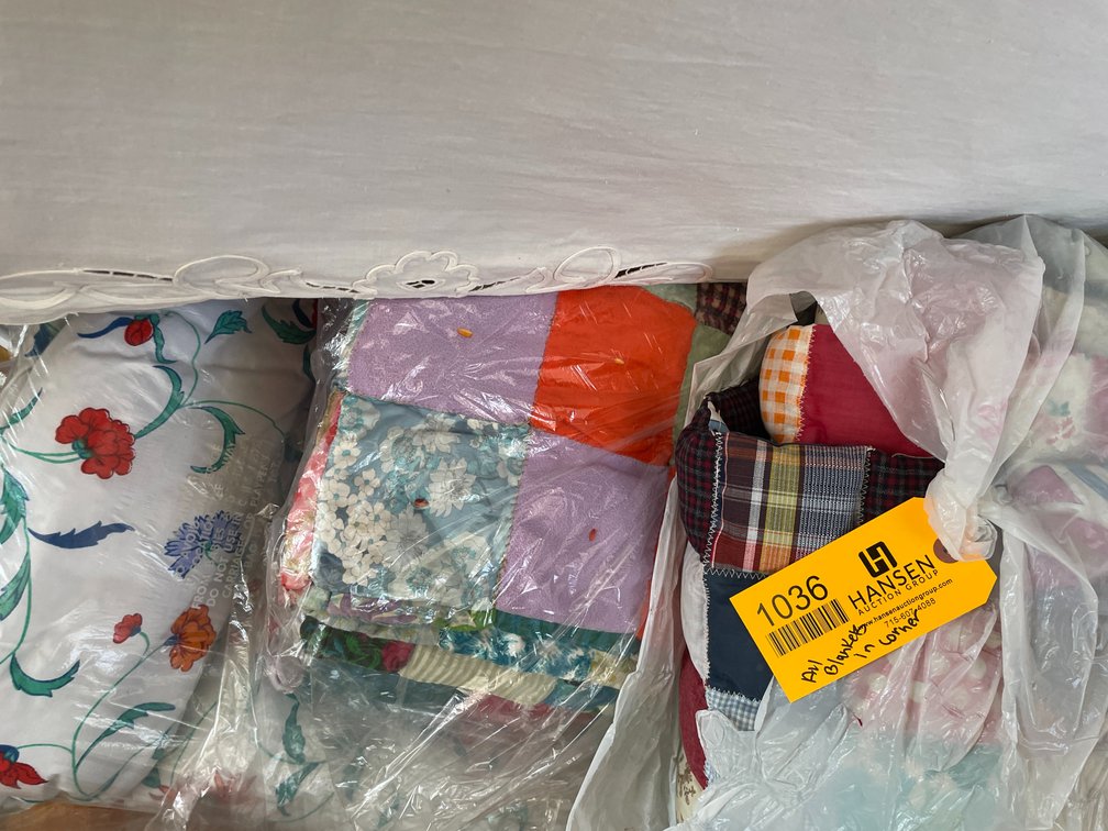 Pile of Various Quilts and Blankets