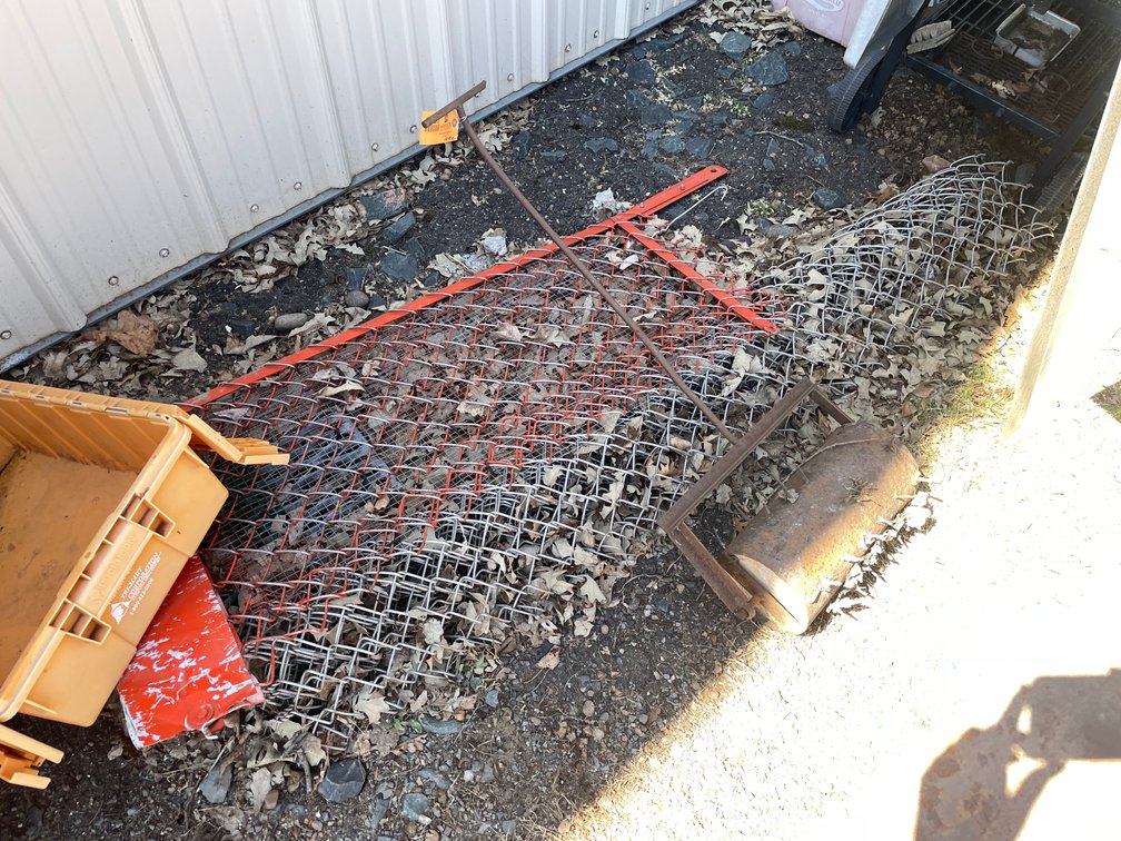 Manual Lawn Aerator and Partial Roll of Chain Link Fence