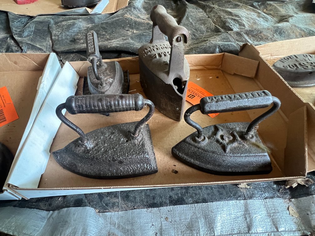 (4) Antique Sad Irons and (1) Trivet