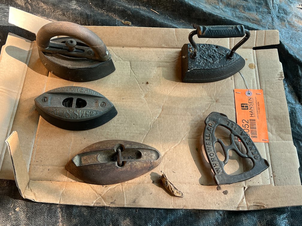 (4) Antique Cast Sad Irons and (1) Trivet