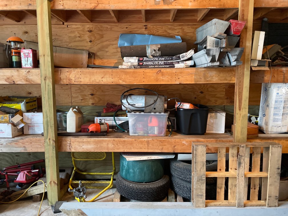 Contents of Shelving Unit Including GAF Shingles, Gas Heater, Tires, Hardware, and More