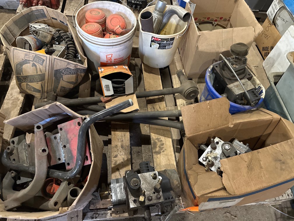 Pallet of Hydraulic Assemblies, Linkage Rods, Mounting Brackets, Clay Targets, and More