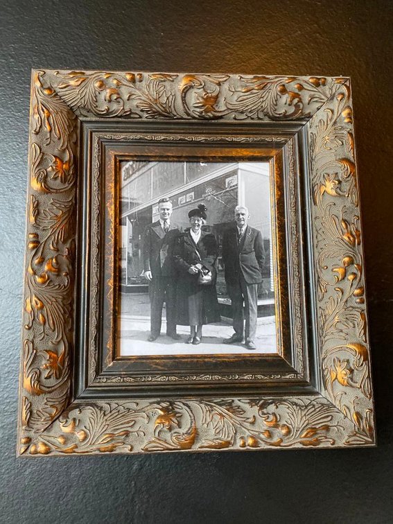 Medium Sized People Outside Historic Main Ave Store In Ornate Frame