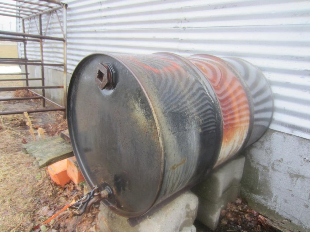 Metal 55 Gallon Oil Barrel with Cement Blocks