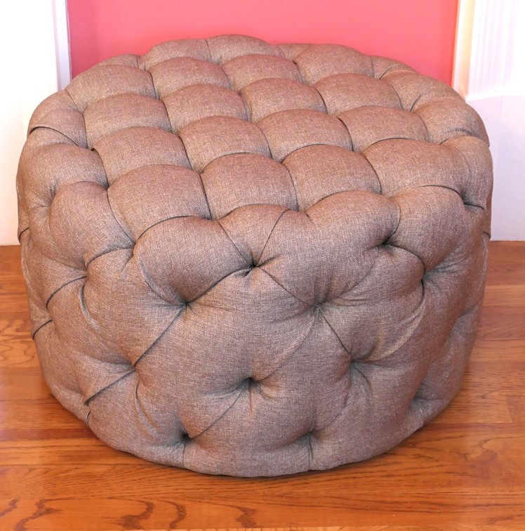 Gray Upholstered Button  and Tuck Ottoman