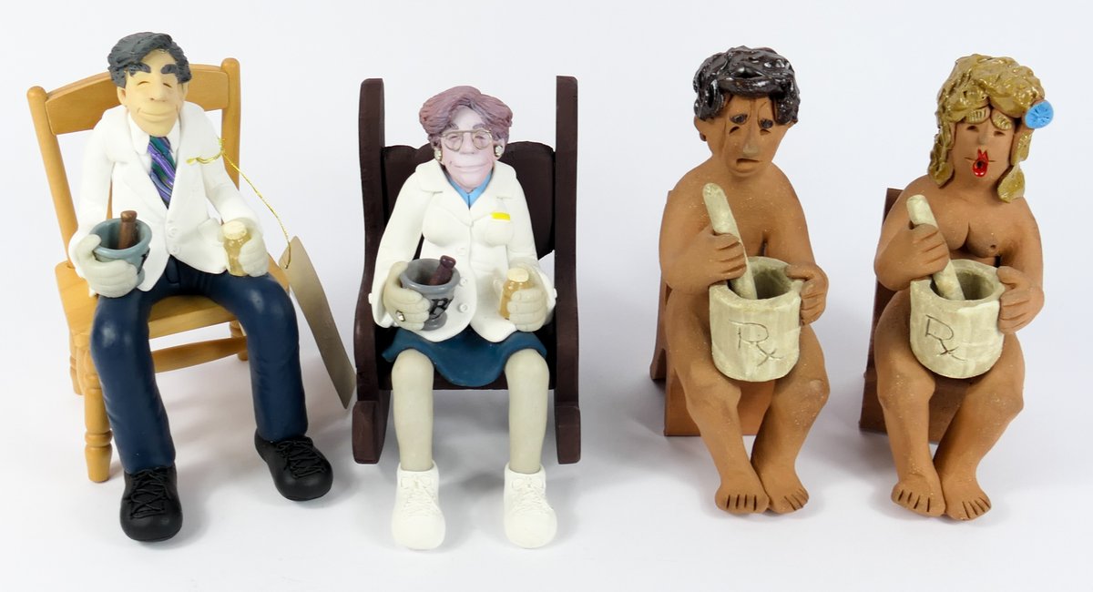 Four Sitting Pharmacist Figurines