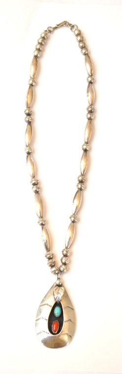 A White Navajo-made Sterling Silver Necklace with Central Pendant Featuring Turquoise and Coral.