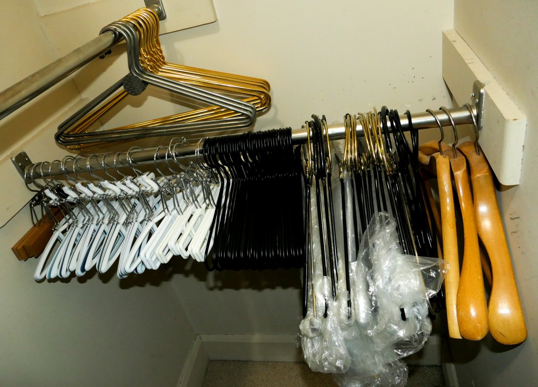 Large Grouping of Metal and Plastic Clothes Hangers