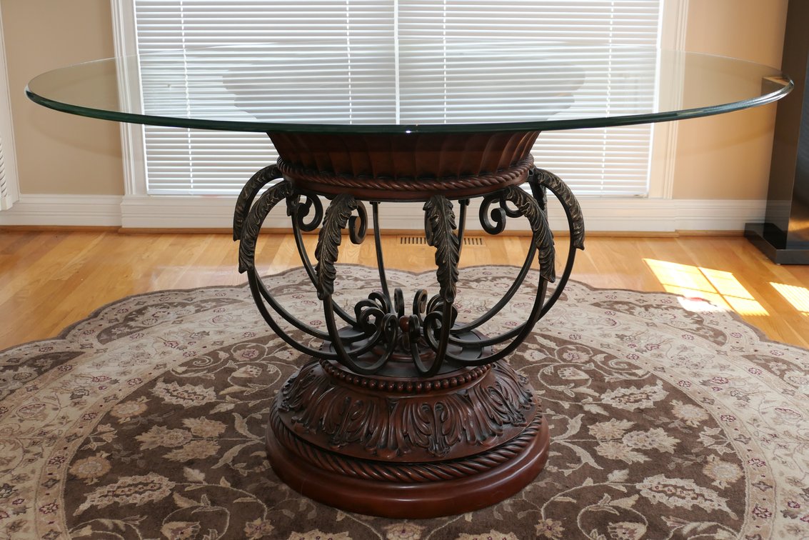 Round Glass Top Kitchen Table On an Ornate Cast Metal and Wood Base