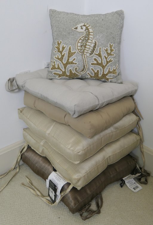 Stack of Tan and Taupe Seat Cushions