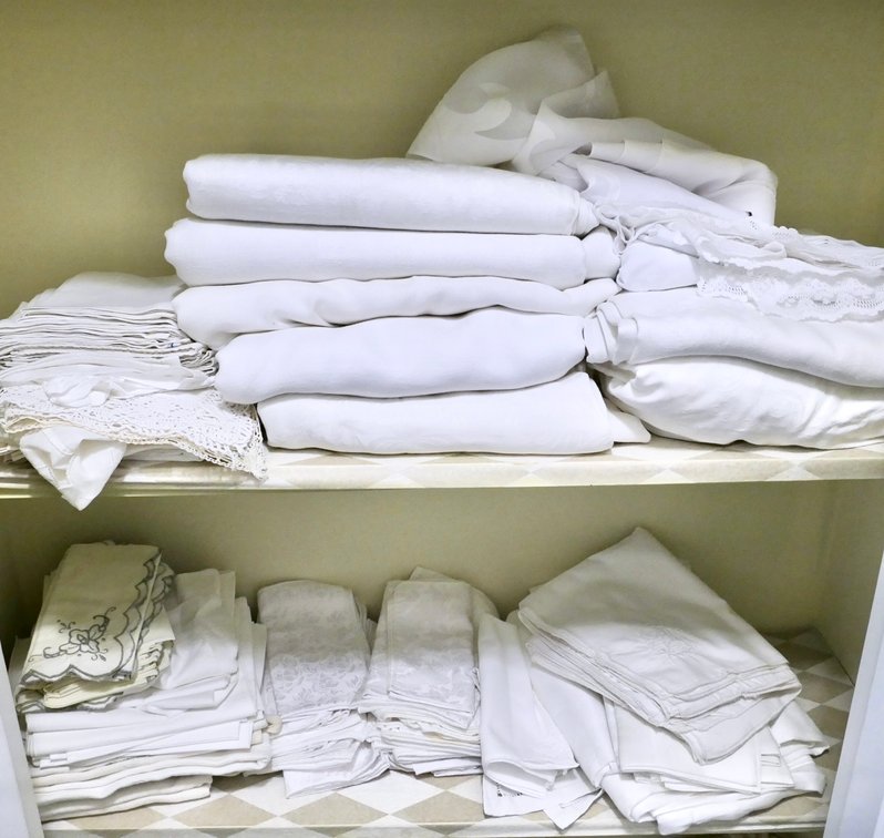 Two Shelves of Table Linens