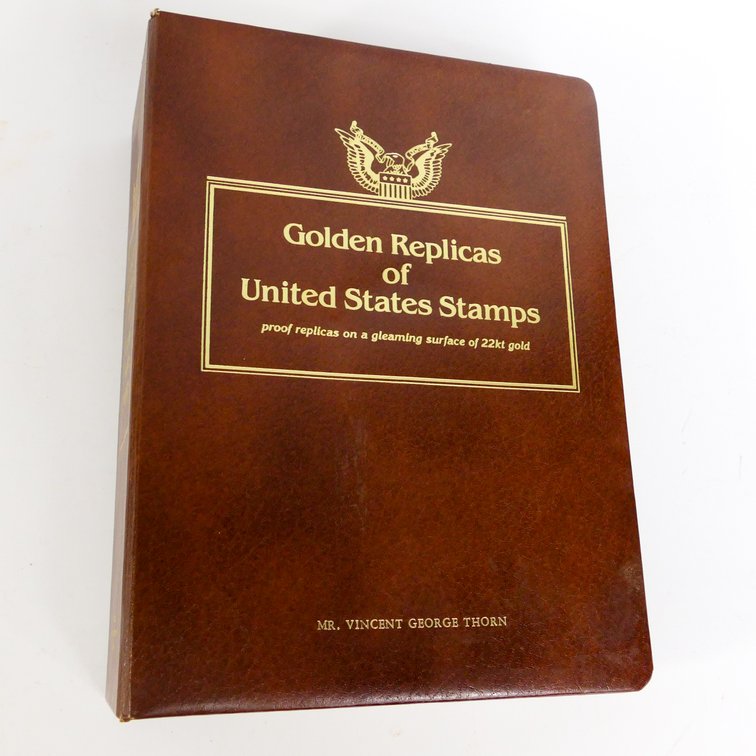 Binder of Gold Tone Stamp Replicas