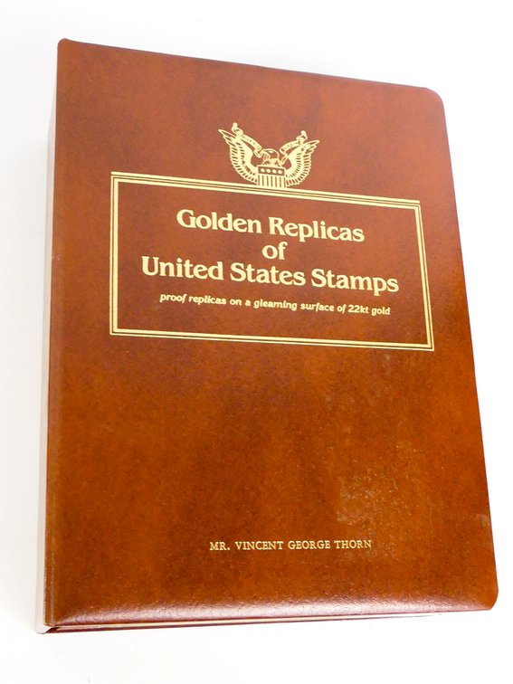 Binder of Gold Tone Stamp Replicas