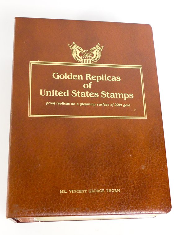 Binder of Gold Tone Stamp Replicas