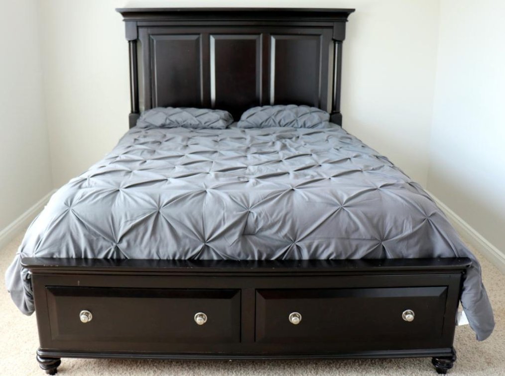 Queen-size platform bed with two drawers underneath and paneled headboard