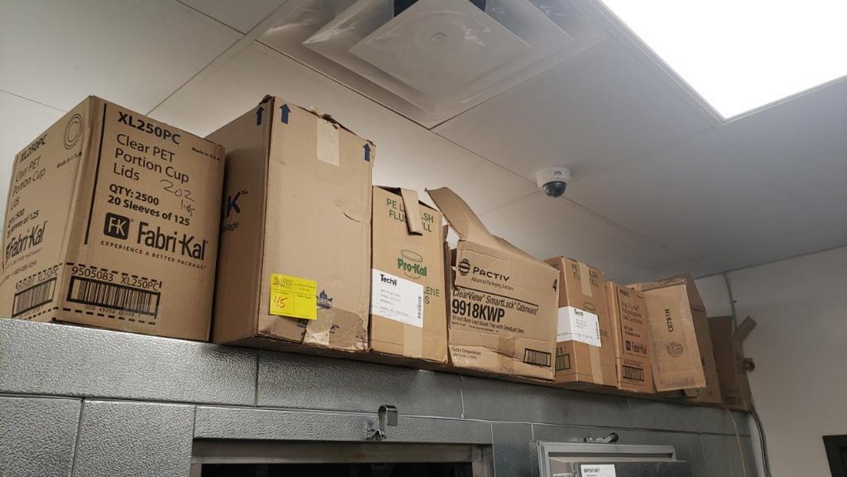 Assortment of Boxed Items On Top of Walk-In Cooler