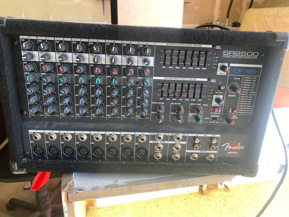 Fender SR8500 8-channel powered mixer in a black carpeted enclosure.