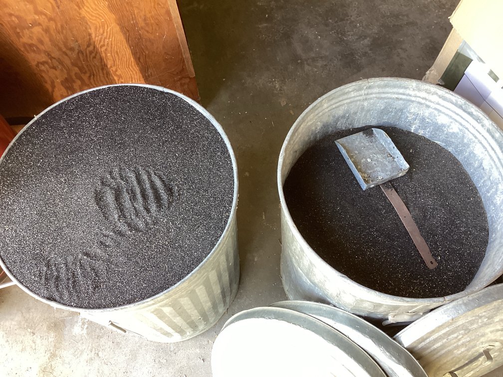 2- 20 Gallon Trash Cans, Filled With Black Sand