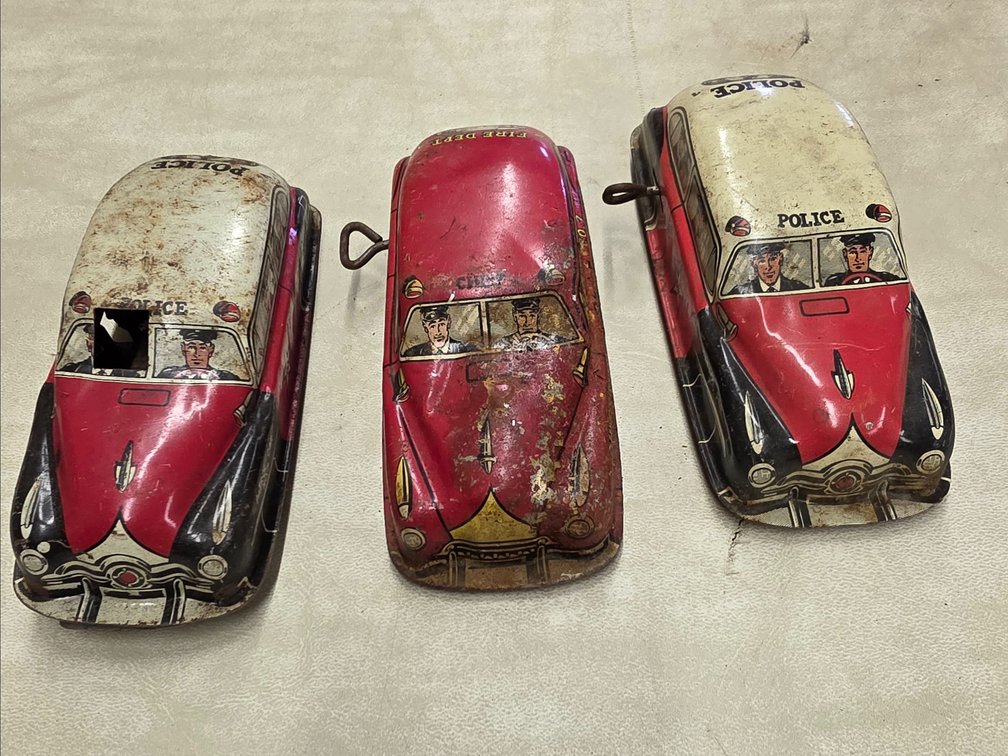 Pressed tin lithograph toy car with printed drivers and "POLICE and Fireman" graphics