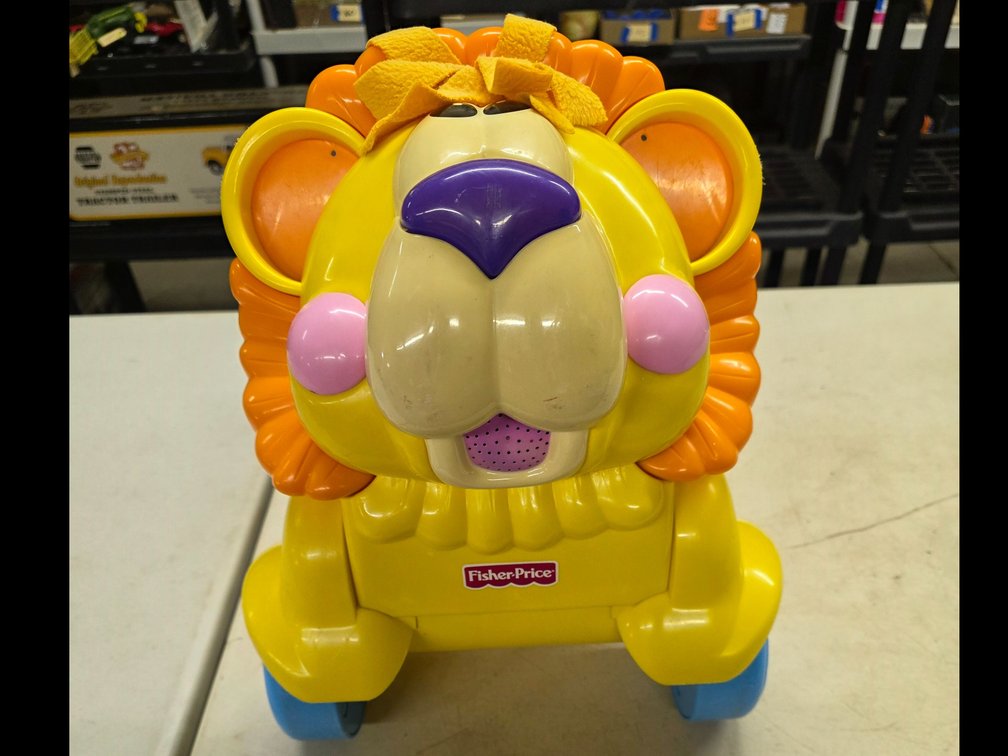 Fisher-Price 3-in-1 Sit, Stride & Ride Interactive Lion toy.