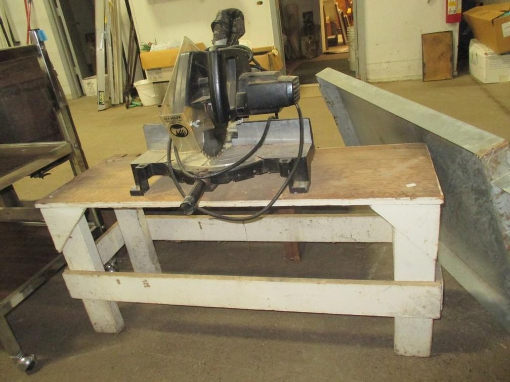 Craftsman power miter saw on wood stand