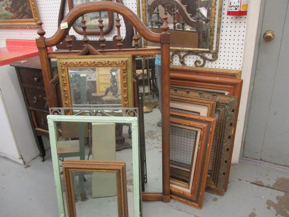 Group of framed mirrors and picture frames