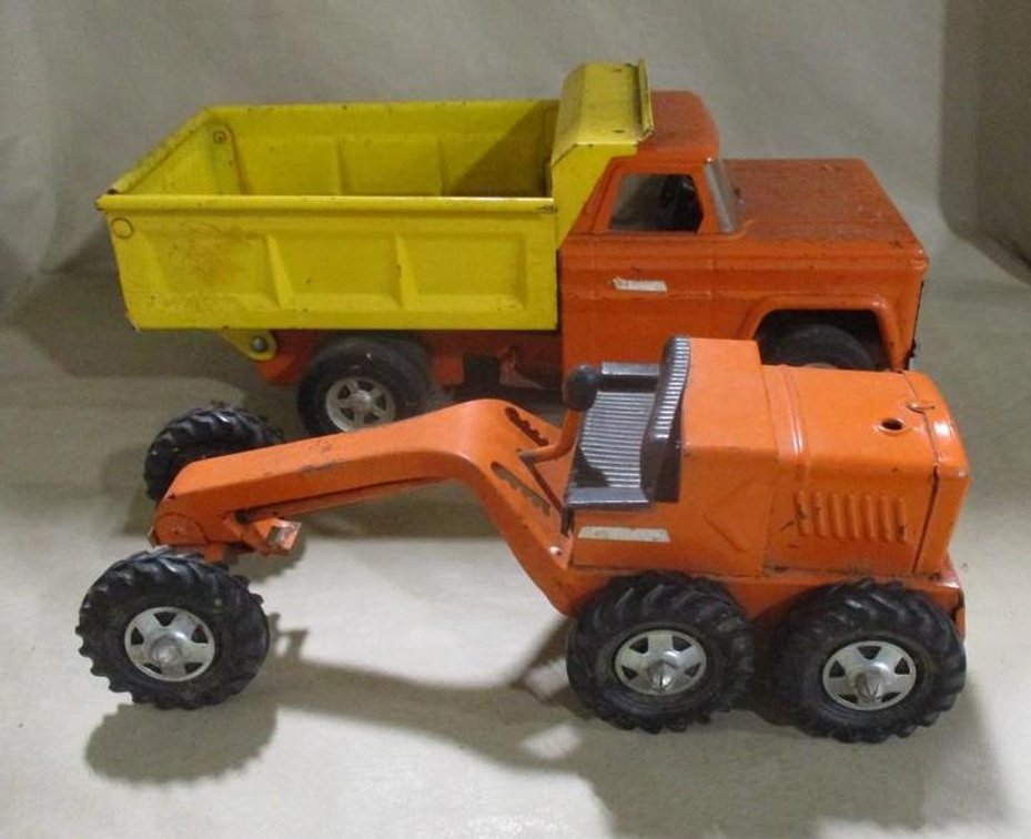 Pressed metal dump truck and road grader