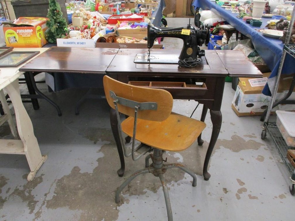 Antique Singer sewing machine in wood cabinet