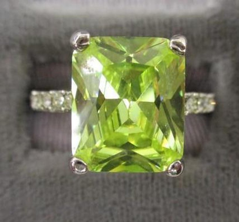 Brilliant emerald cut yellow iridescent stone ring