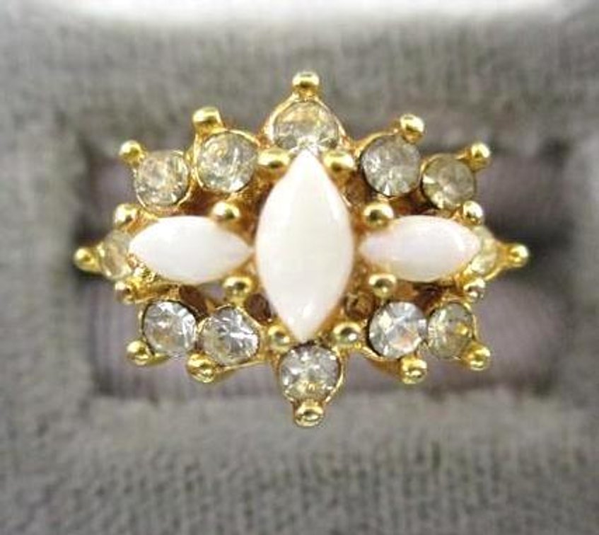 Inner marked gold tone ring with clear and cream tone stones