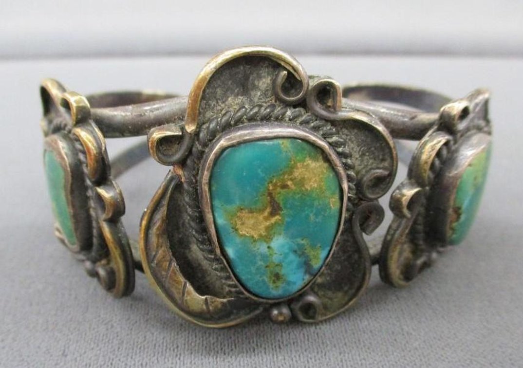 Silver tone cuff bracelet with turquoise accents