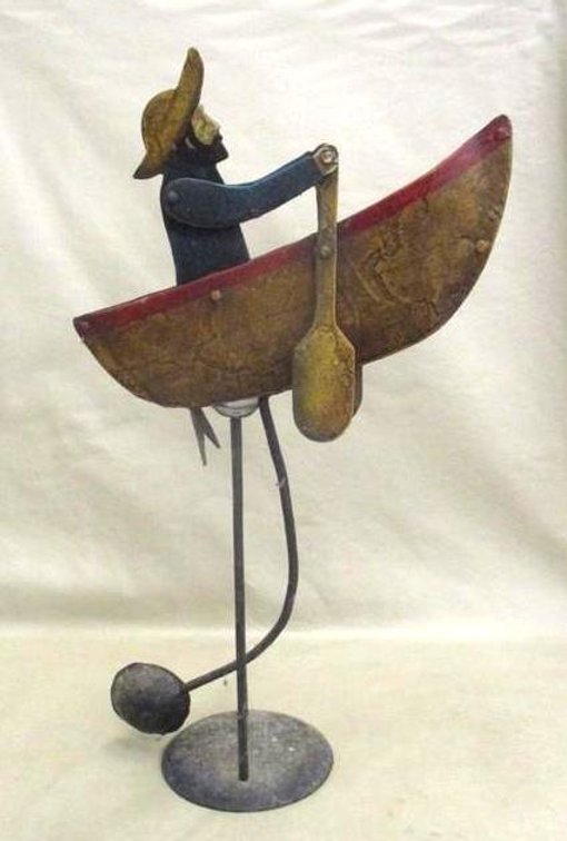 Metal man rowing boat decor
