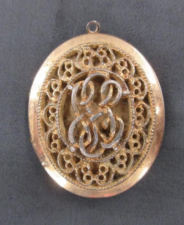 Ornate front gold tone locket