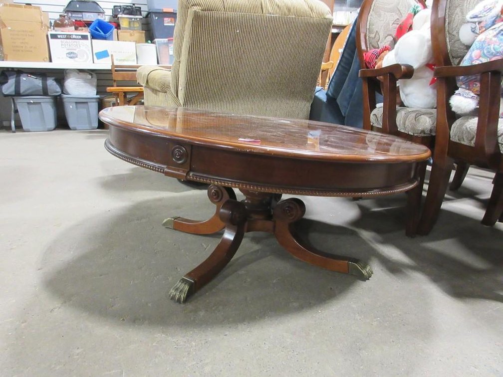 Round wooden coffee table on pedestal