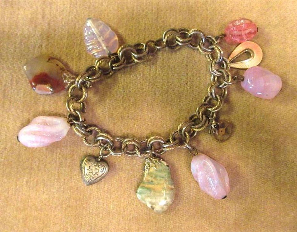 Unmarked silver bracelet with sterling charms and stones