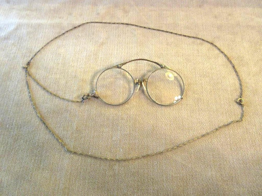 Pair of antique yellow gold plated glasses with chain