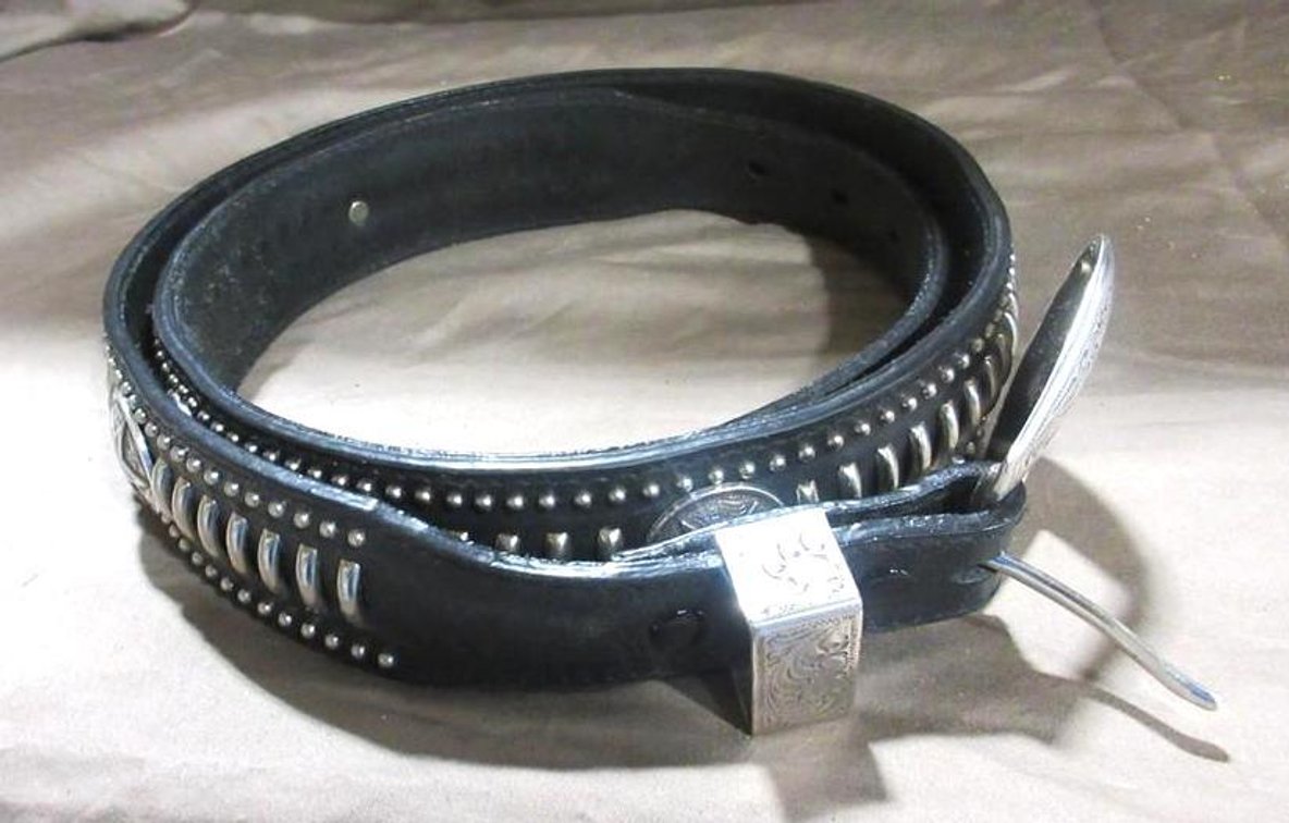 Black leather belt with metal adornment