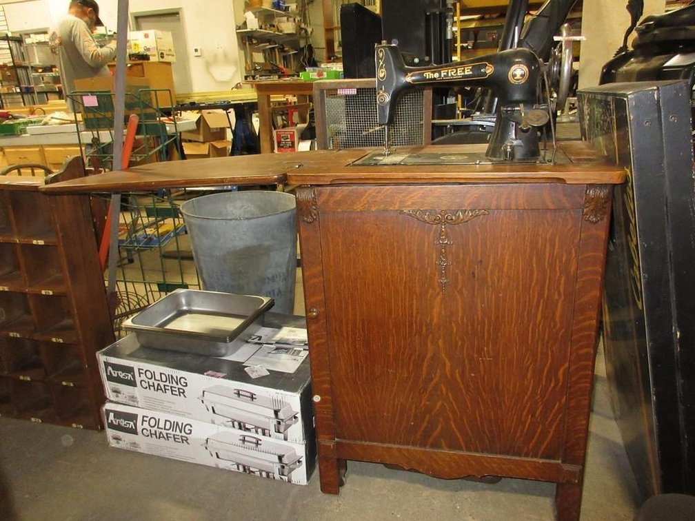 The Free Sewing Machine treadle sewing machine in wooden cabinet